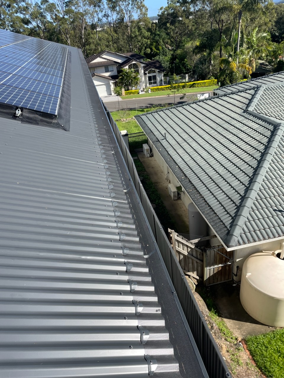 Completed birdproofing mesh system protecting solar panels from nesting birds — External Powerwash Solutions