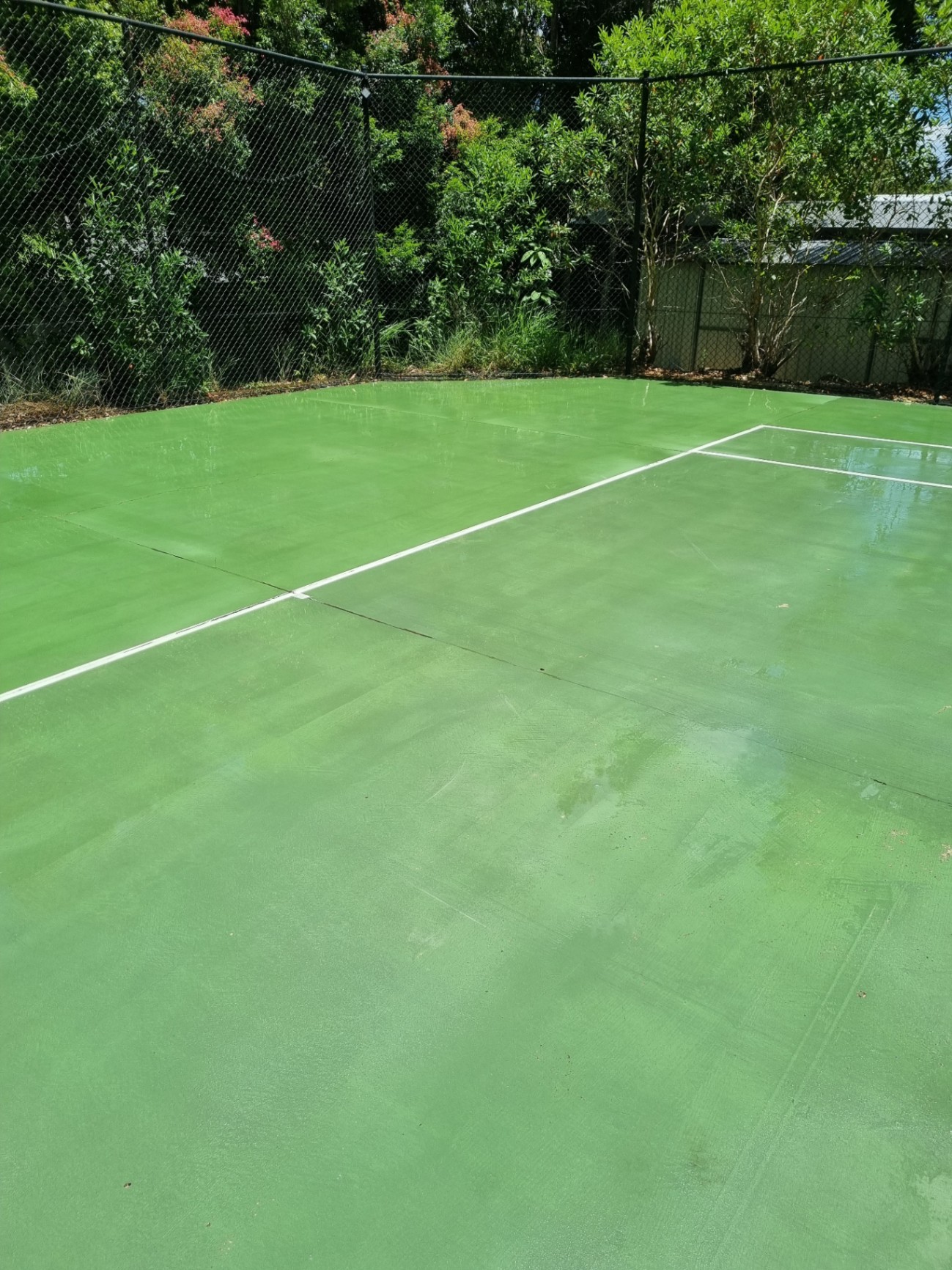 Clean tennis court after professional pressure washing by External Powerwash Solutions — South East Queensland