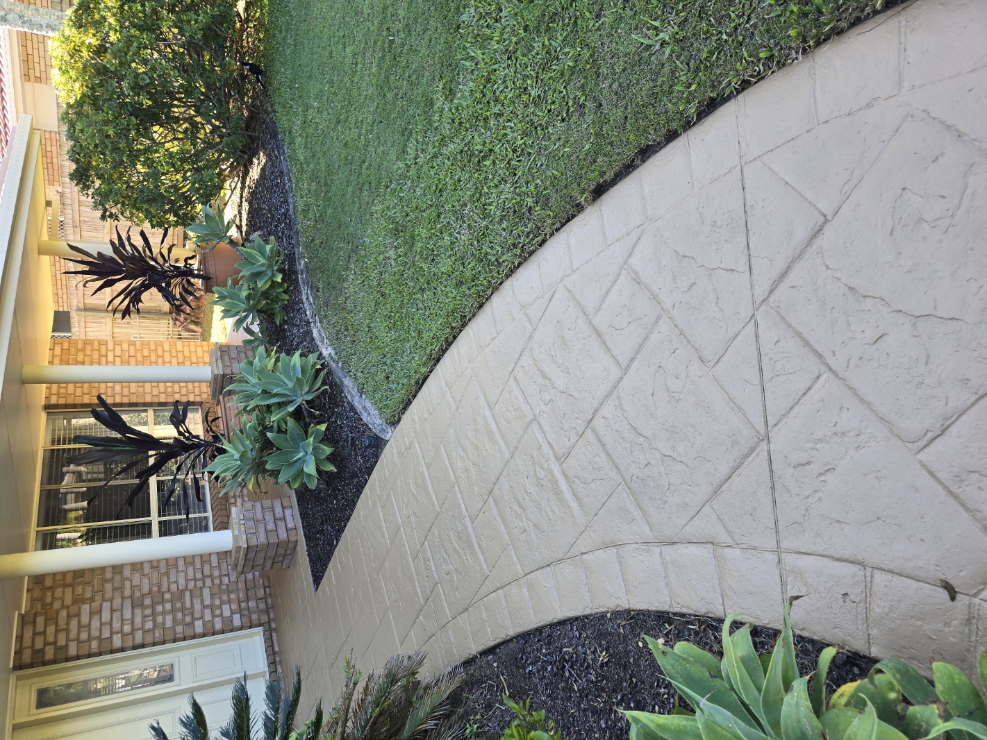 Decorative concrete pathway after professional cleaning and colour sealing — warm tone restored, surface protected